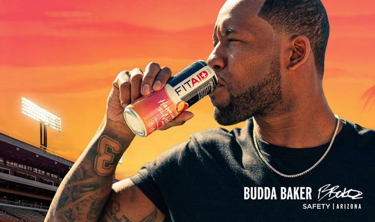 Budda Baker drinking a can of Fitaid Hawaiian Nectar.