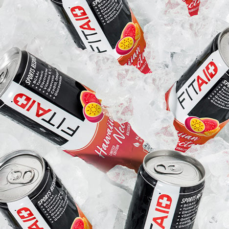 Several cans of FITAID Hawaiian Nectar surrounded by ice cubes.