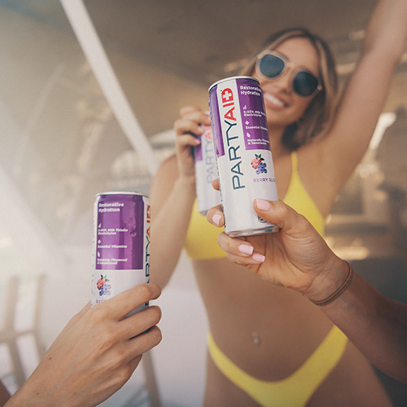 People partying while holding a can of PARTYAID.