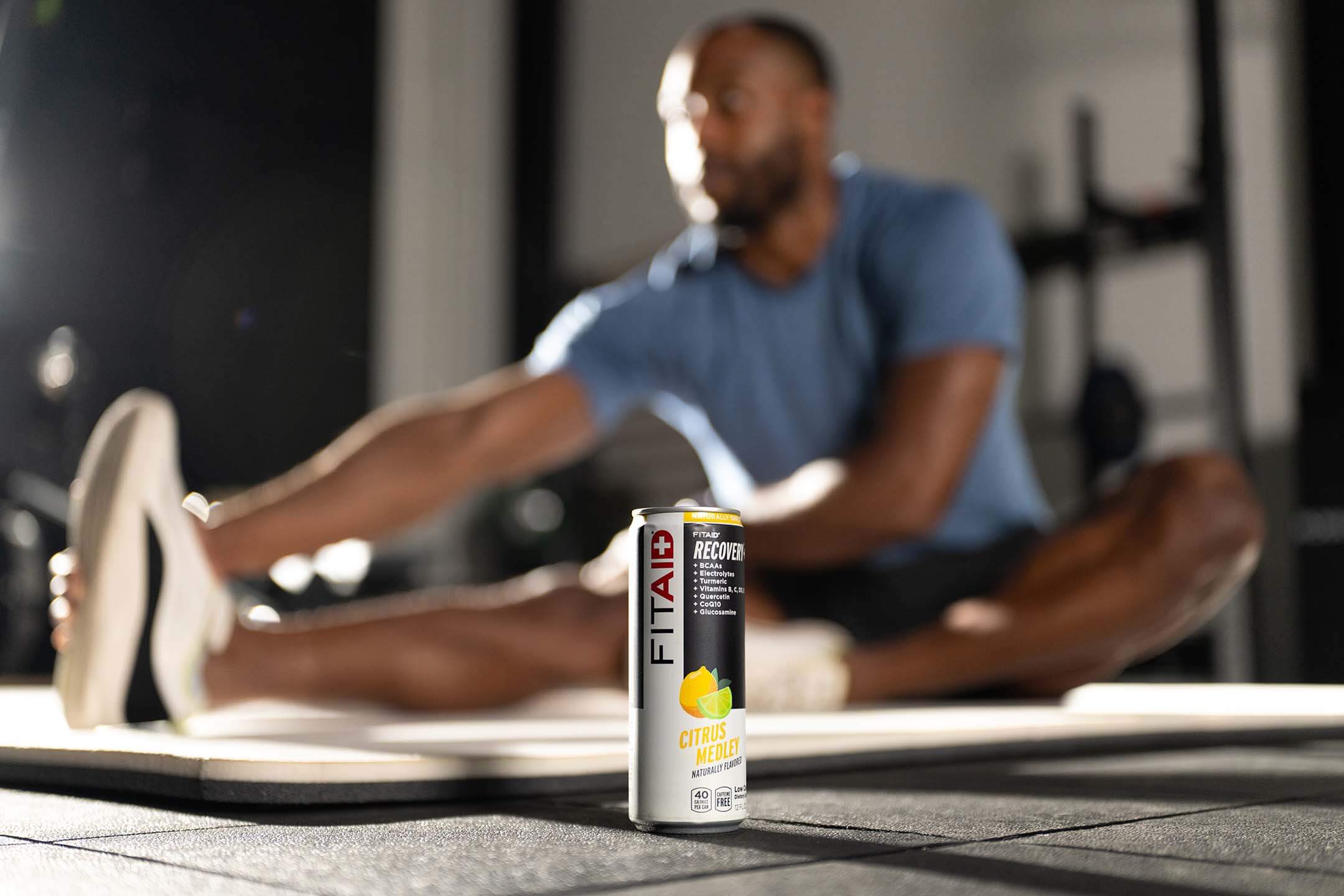 A can of FITAID with fitness equipments