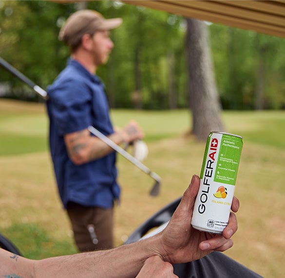 A golfer holding a can of GOLFERAID.