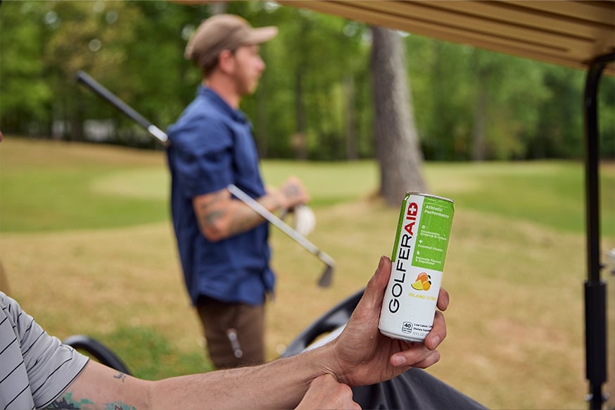 A golfer holding a can of GOLFERAID.