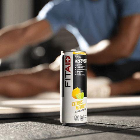 A can of FITAID with fitness equipments