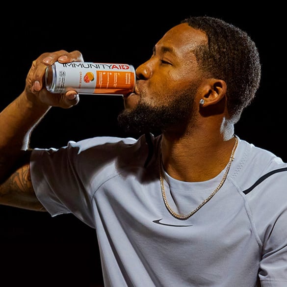 Budda Baker drinking a can of IMMUNITYAID.