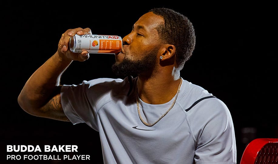 Budda Baker drinking a can of IMMUNITYAID.